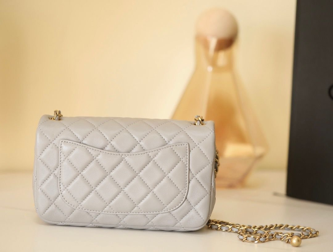 Reference image illustrating Replica Chanel Golden Ball Flap Bag in Grey – A Detailed Style Guide