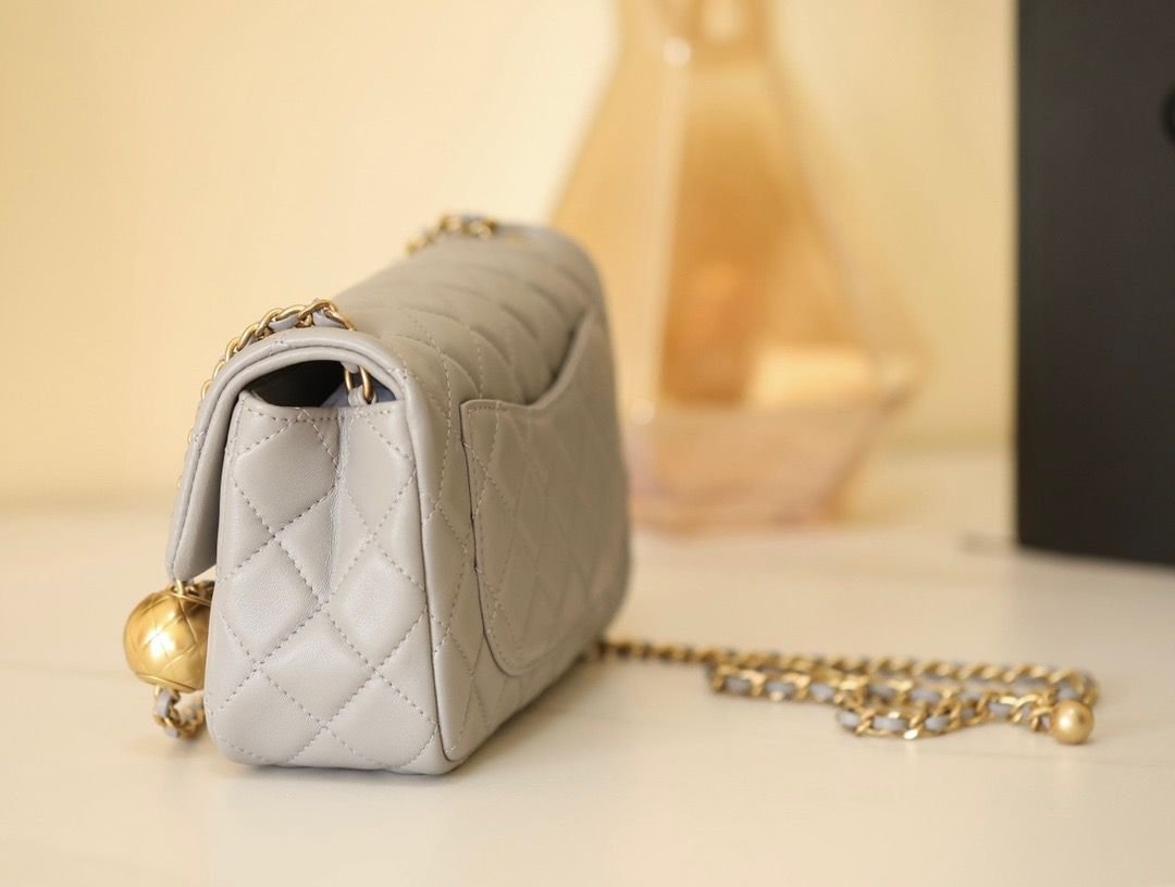 Reference image illustrating Replica Chanel Golden Ball Flap Bag in Grey – A Detailed Style Guide
