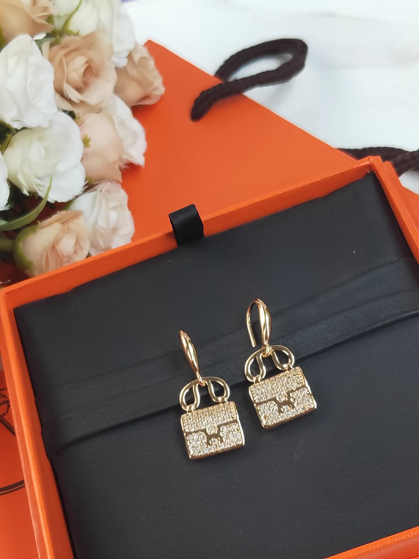 Reference image illustrating Replica Hermès Constance Amulette Earrings: A Detailed Style Guide