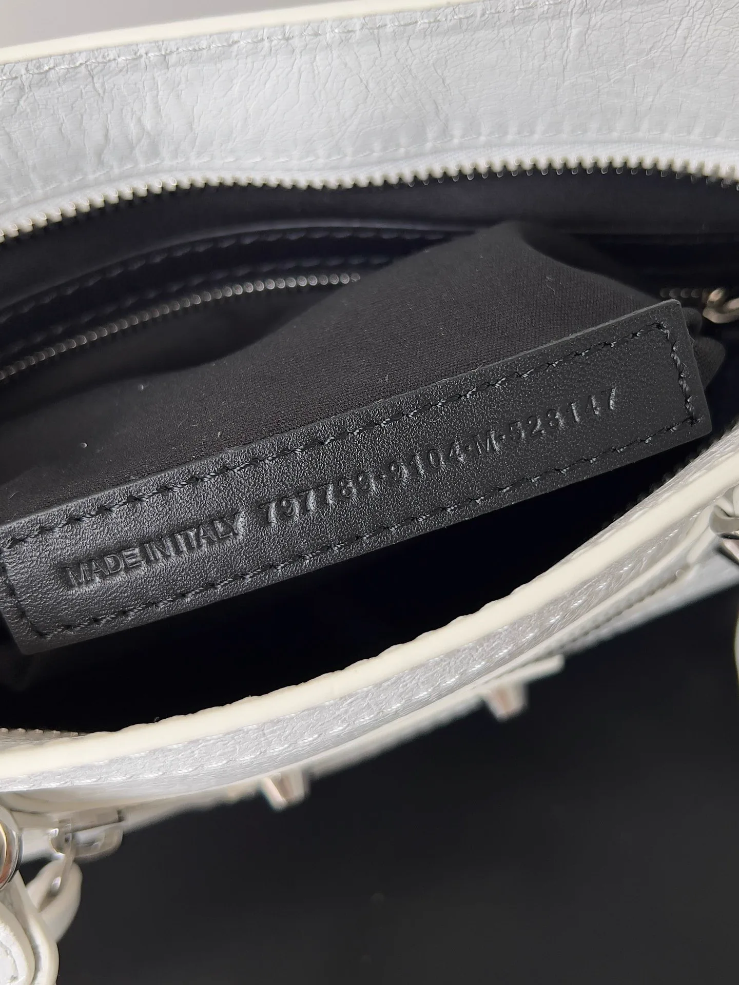Reference image illustrating Replica Balenciaga Le City Small Bag in White Arena Lambskin: A Style Icon Reimagined