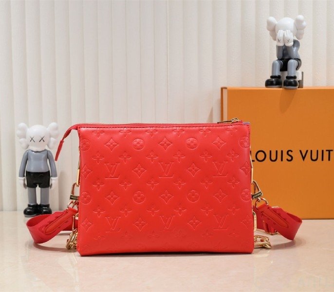 Reference image illustrating Replica Louis Vuitton Coussin PM Bag in Neon Red with Jacquard Strap