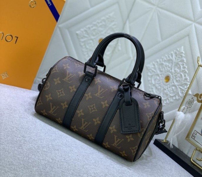 Reference image illustrating Replica Louis Vuitton Monogram Canvas Keepall Bandouliere 25 in Black – A Compact Travel Icon