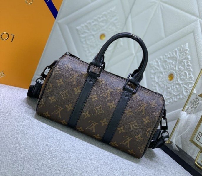 Reference image illustrating Replica Louis Vuitton Monogram Canvas Keepall Bandouliere 25 in Black – A Compact Travel Icon