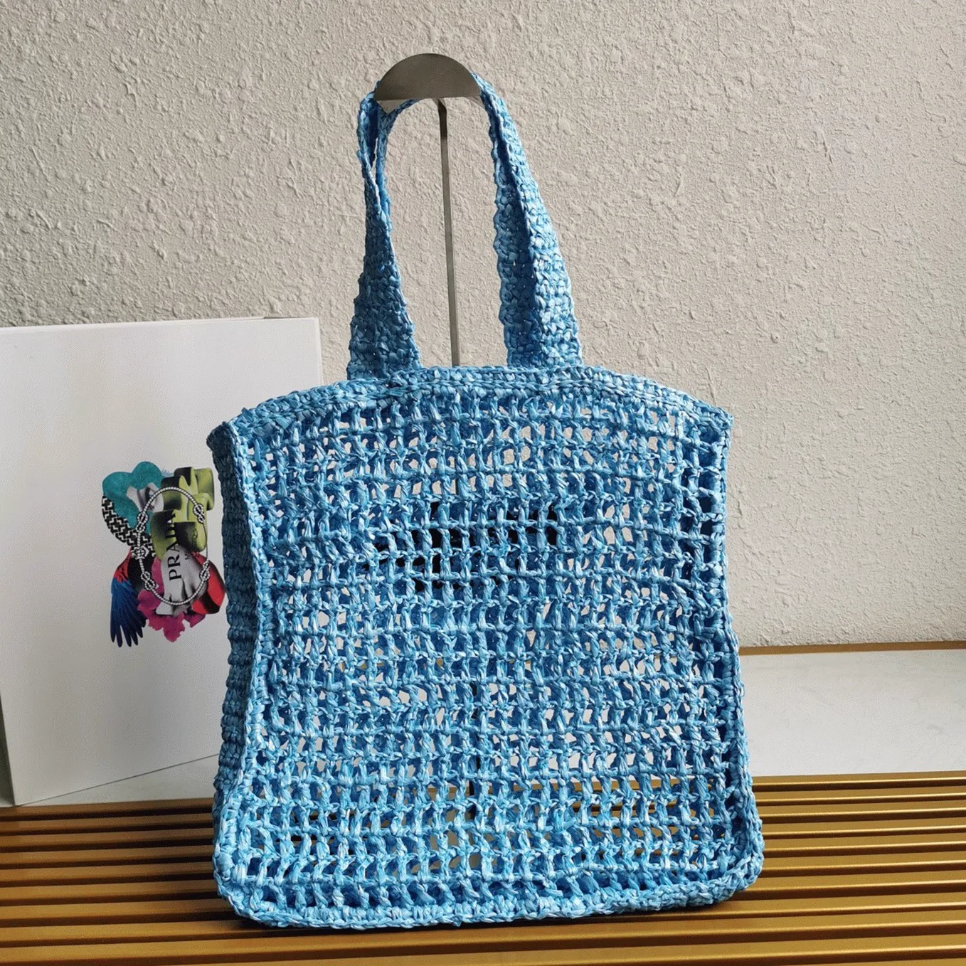 Reference image illustrating Replica Prada Small Raffia Tote Bag in Blue Woven Straw – Summer Style Guide