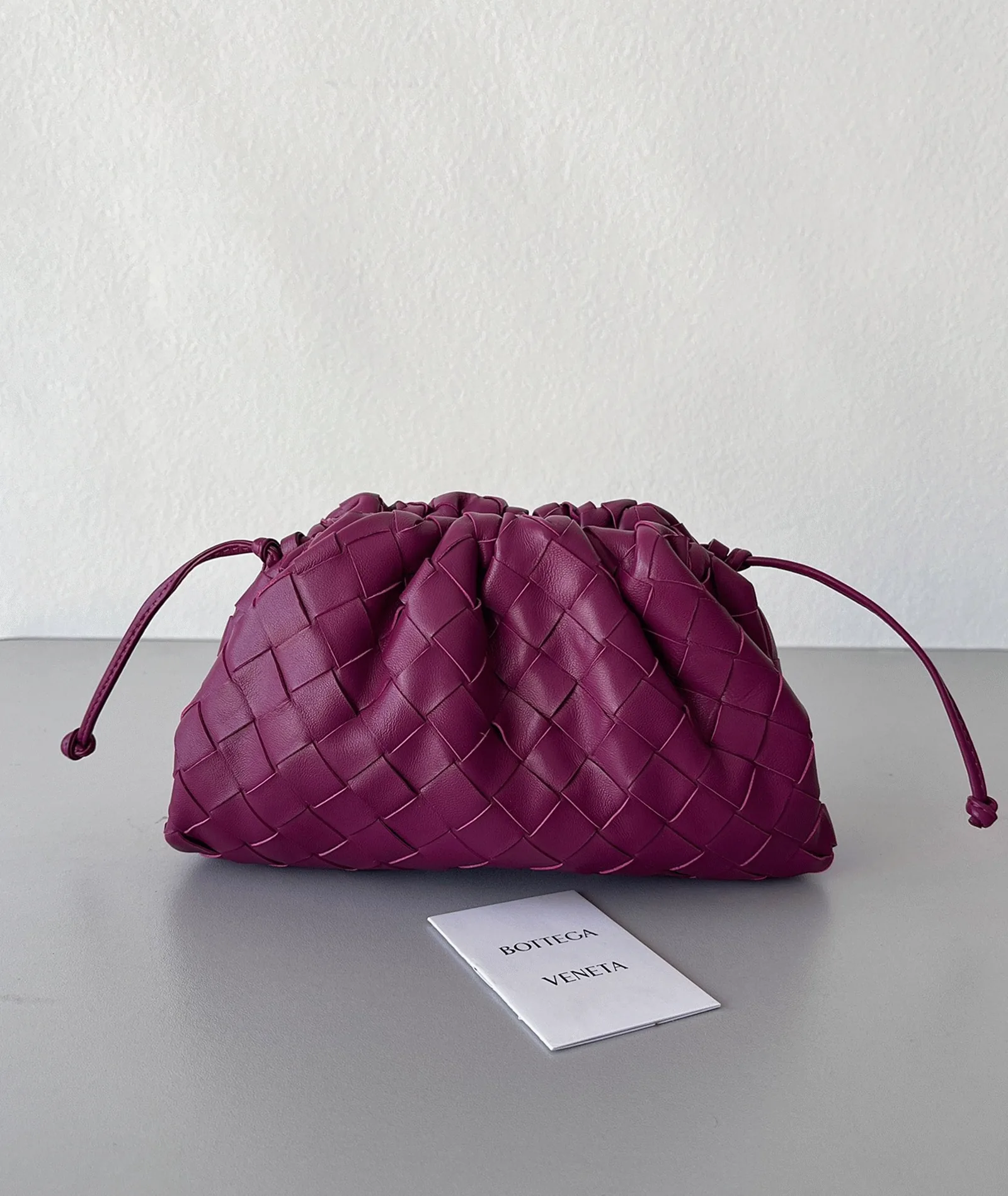 Reference image illustrating Replica Bottega Veneta Mini Pouch with Strap Cinnabar – Design, History & Styling Guide