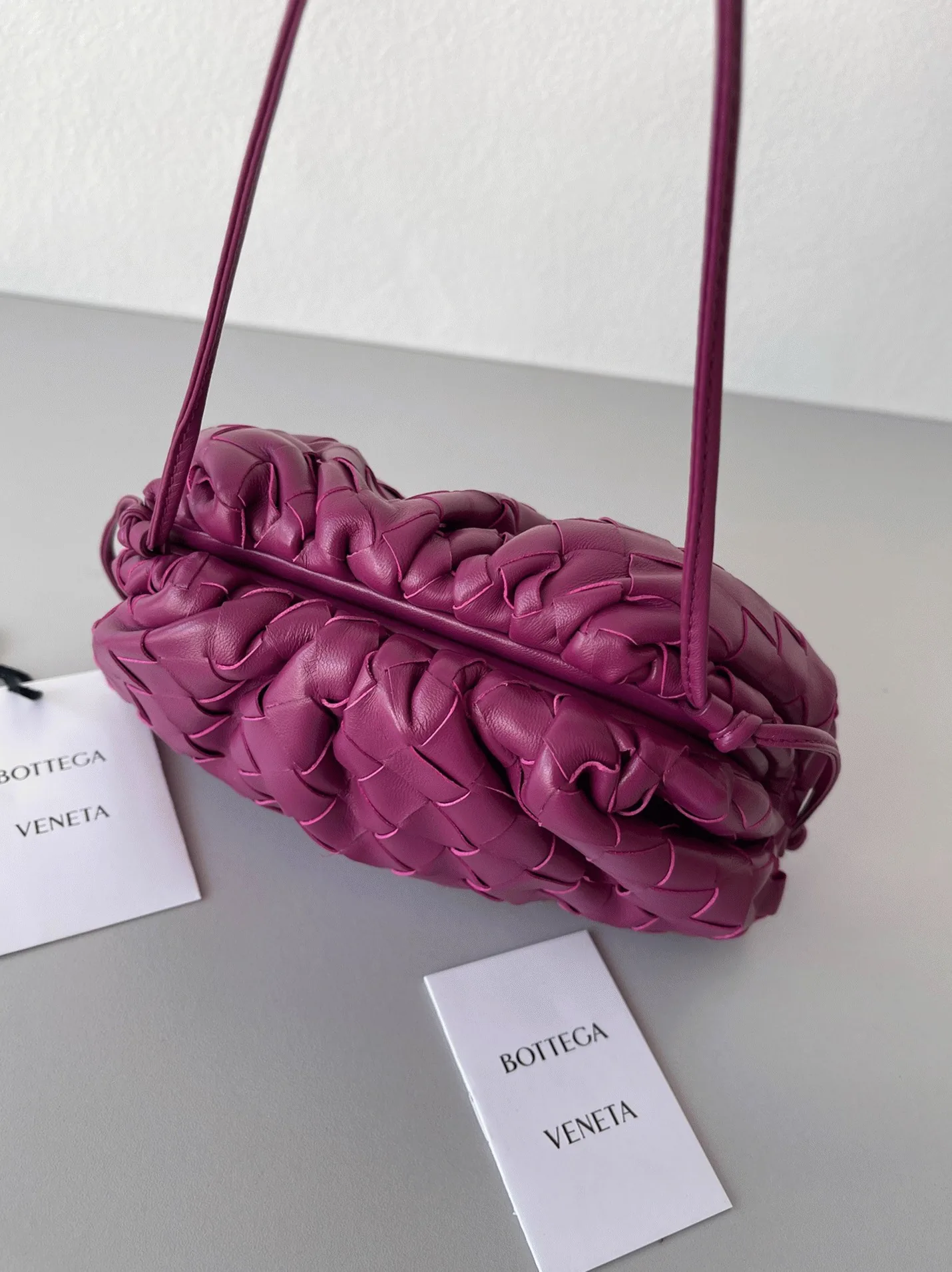Reference image illustrating Replica Bottega Veneta Mini Pouch with Strap Cinnabar – Design, History & Styling Guide