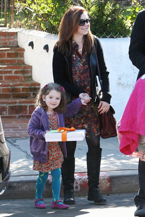 Reference image illustrating Alyson Hannigan’s Prada Madras Satchel: A Casual Family Outing in Venice Beach