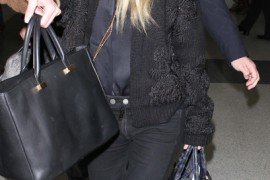 Reference image illustrating Ashley Olsen Uses The Row Day Luxe Tote as a Carry-On and Paparazzi Shield