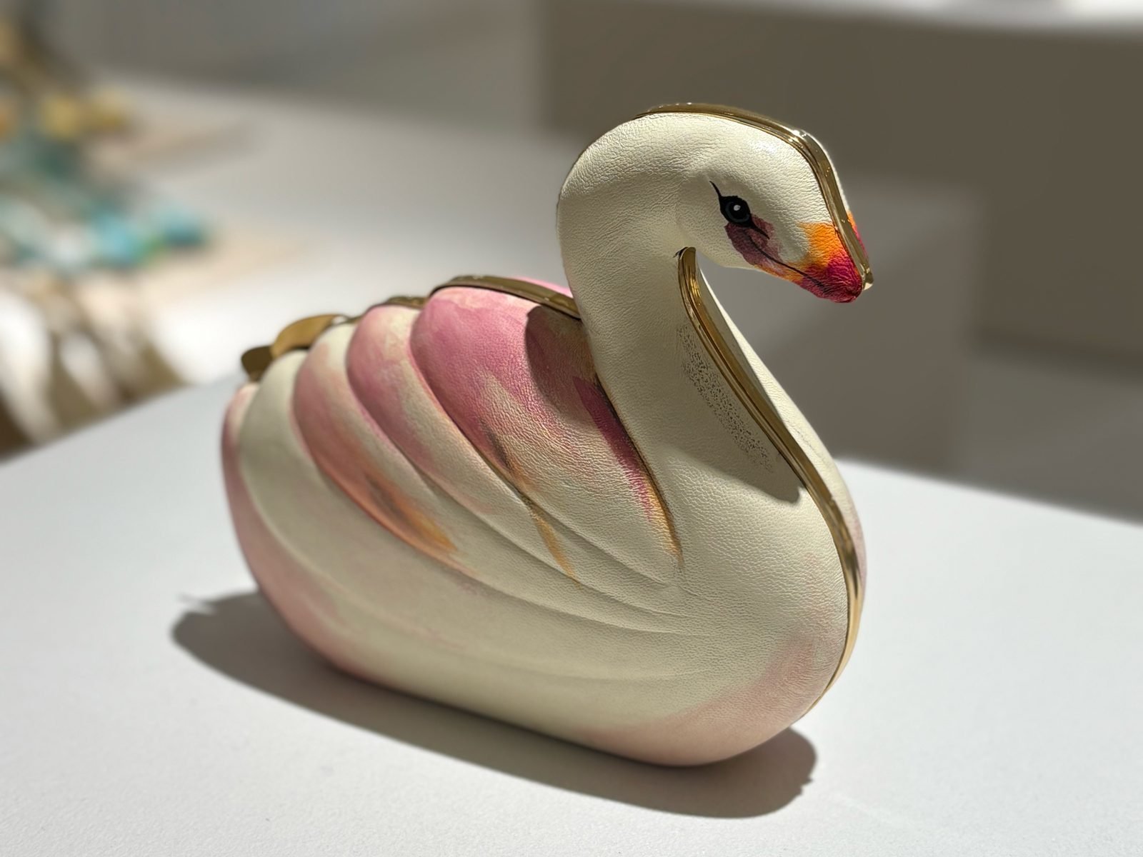 Reference image illustrating Chloé Tropicus Swan Minaudière: The Hand-Painted Statement Bag Dua Lipa Carried This Summer