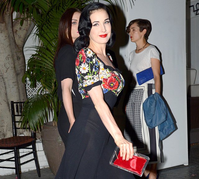 Reference image illustrating Dita Von Teese’s Charlotte Olympia Pandora Perspex Box Clutch: A Retro Fairytale Moment at Chateau Marmont