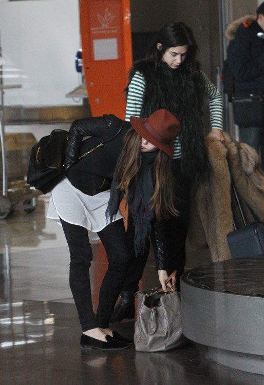 Reference image illustrating Elizabeth Olsen’s Paris Airport Style: Alexander McQueen Heroine Bag and Chanel Carry-On