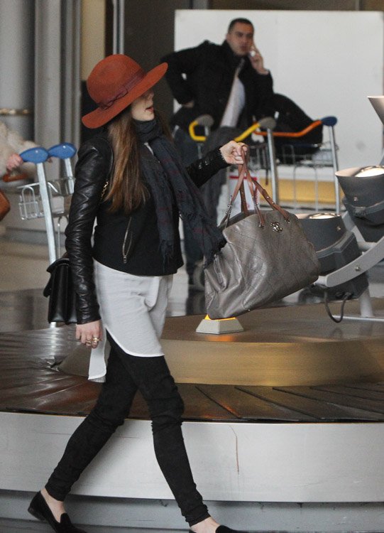 Reference image illustrating Elizabeth Olsen’s Paris Airport Style: Alexander McQueen Heroine Bag and Chanel Carry-On