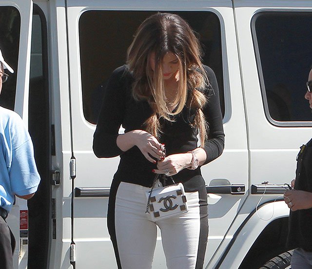 Reference image illustrating Khloe Kardashian Spotted Filming with a Petite Chanel Lego Mini Flap Bag