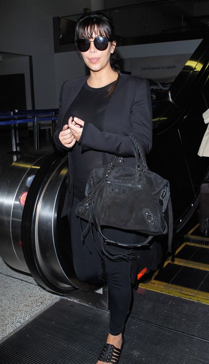 Reference image illustrating Kim Kardashian’s All-Black Airport Look: Balenciaga City Bag and Givenchy Sandals