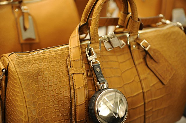 Reference image illustrating Louis Vuitton Men's Fall 2014 Runway: Damier Cobalt Canvas & Crocodile Keepall Bags