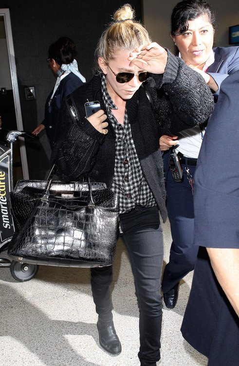 Reference image illustrating Mary-Kate Olsen Travels Through LAX with Nearly $80K in The Row Alligator Bags