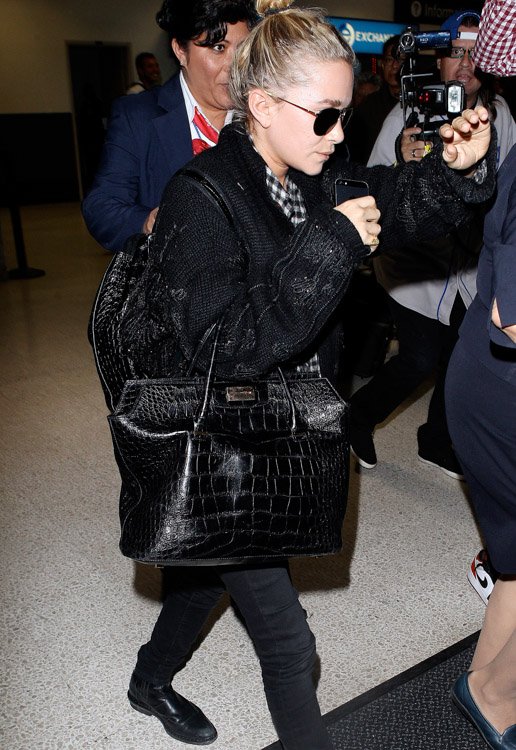 Reference image illustrating Mary-Kate Olsen Travels Through LAX with Nearly $80K in The Row Alligator Bags