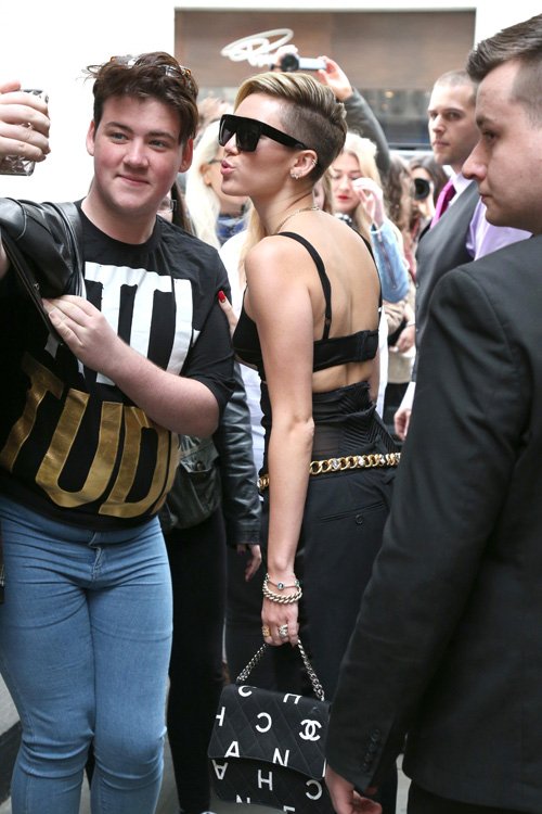 Reference image illustrating Miley Cyrus Spotted in London with a Vintage-Inspired Chanel Logo Flap Bag