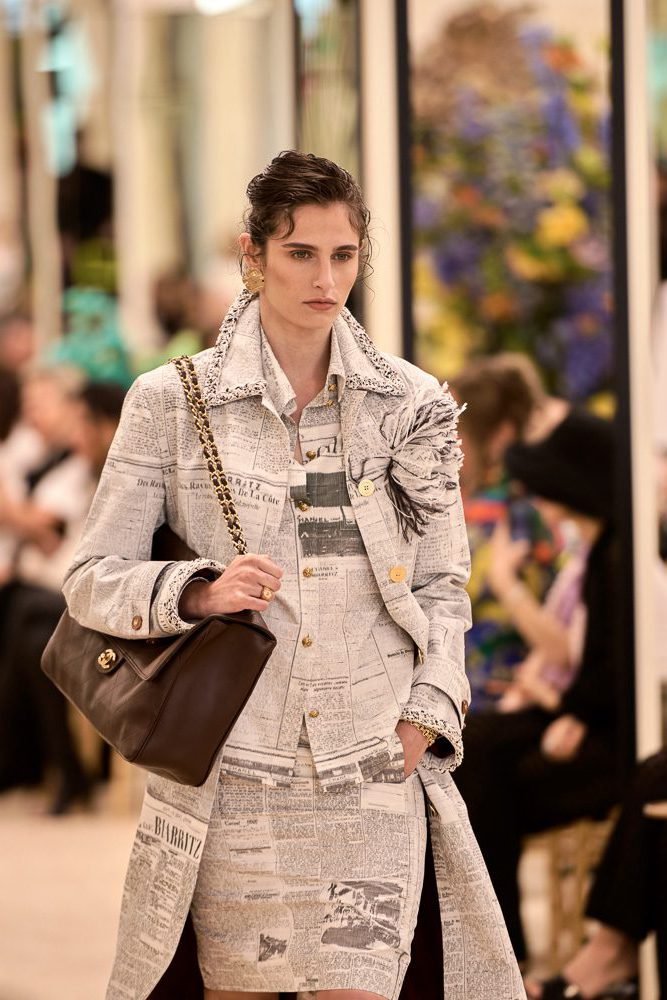 Reference image illustrating The Great Newsprint Bag Battle: Chanel vs. Dior vs. Fashion History