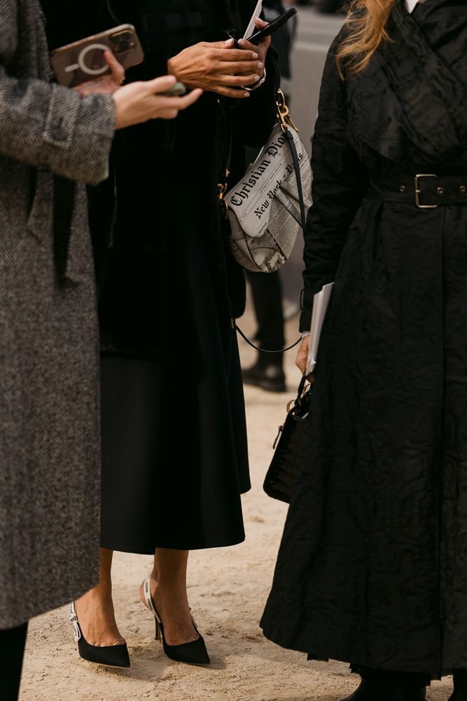 Reference image illustrating The Great Newsprint Bag Battle: Chanel vs. Dior vs. Fashion History