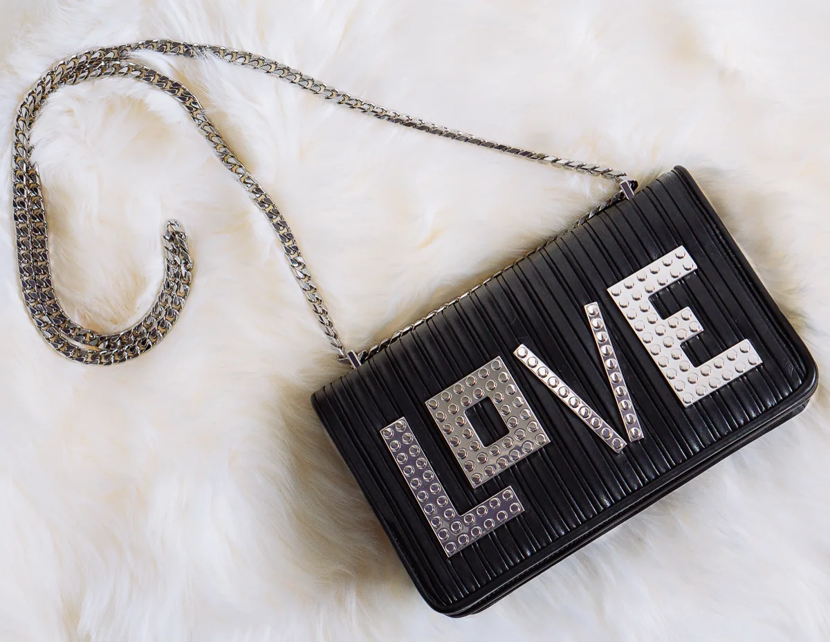 Reference image illustrating Les Petits Joueurs LOVE Shoulder Bag Review: A Day-to-Night Black Chain Bag with Playful Detail