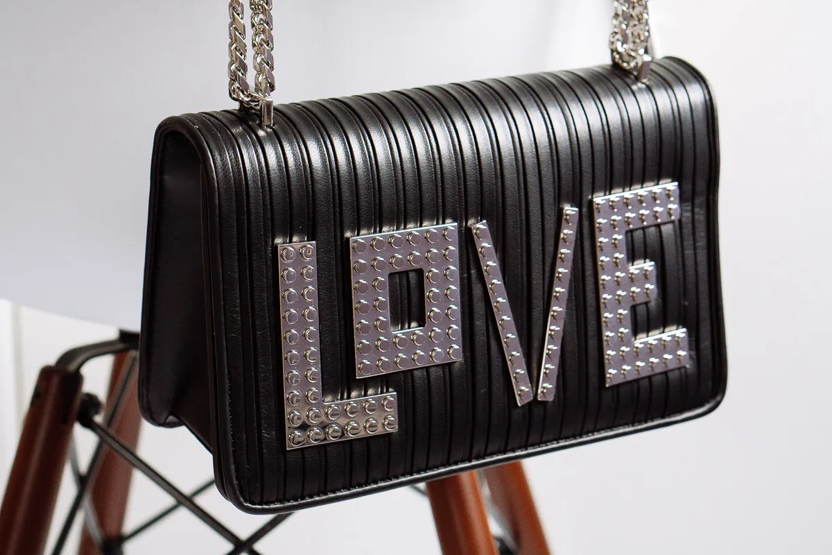 Reference image illustrating Les Petits Joueurs LOVE Shoulder Bag Review: A Day-to-Night Black Chain Bag with Playful Detail