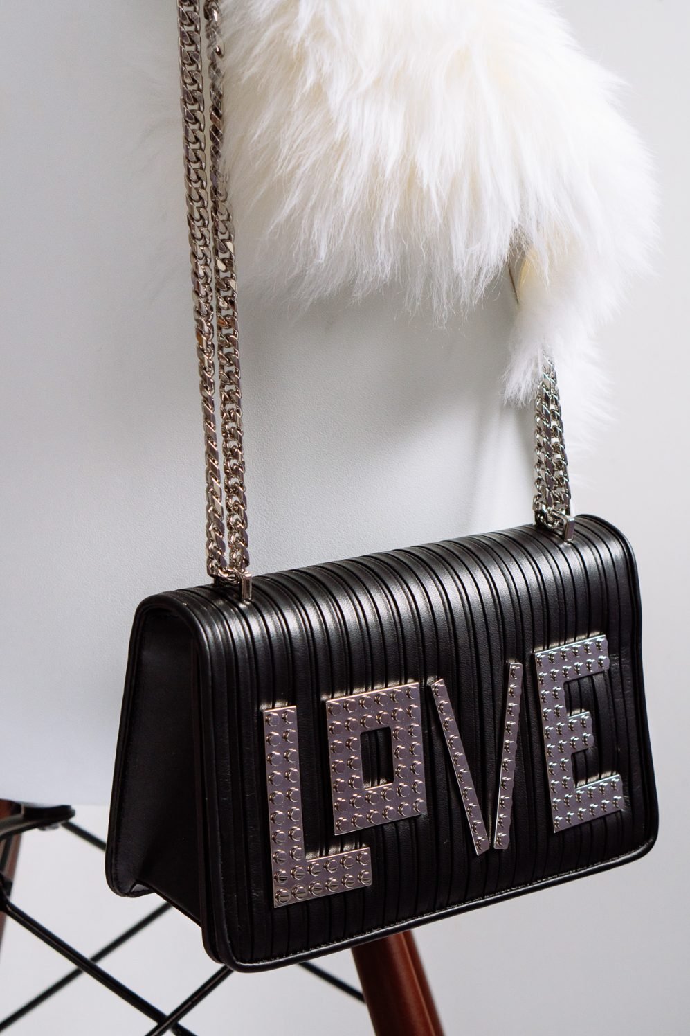 Reference image illustrating Les Petits Joueurs LOVE Shoulder Bag Review: A Day-to-Night Black Chain Bag with Playful Detail