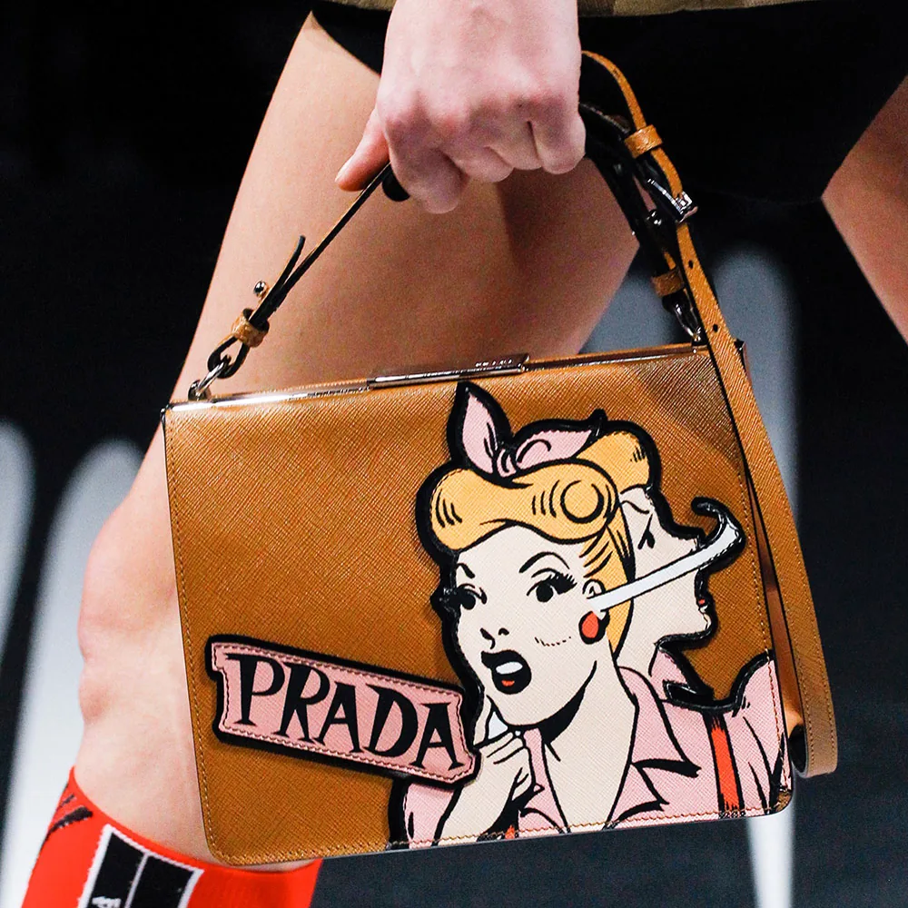 Reference image illustrating Prada Spring 2018 Runway Bags: Nylon, Comic Heroines, and Punk Details
