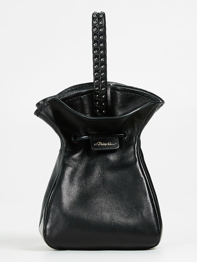 Reference image illustrating Why Top-Strap Clutches Are the Indie Handbag Trend You Need to Know